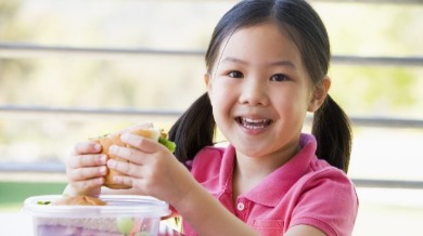 child eating a sandwich | Island Real Estate