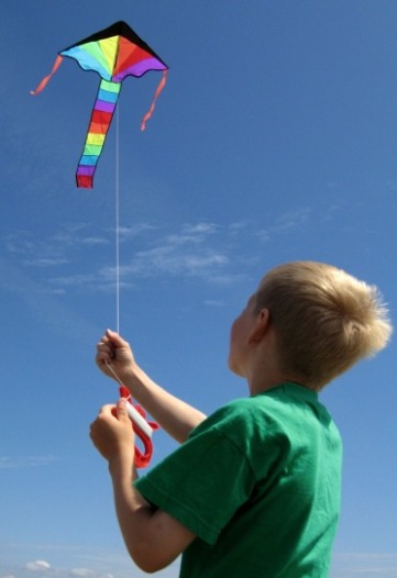 child flying a kite