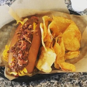 hot dog and chips from SurfDog Bites & Brews | Island Real Estate