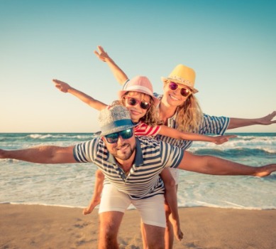 Happy family on the beach | Island Real Estate Topsail Island Vacation Rentals