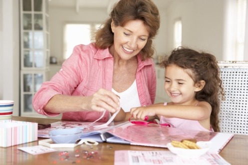 woman and child assembling scrapbook | Island Real Estate