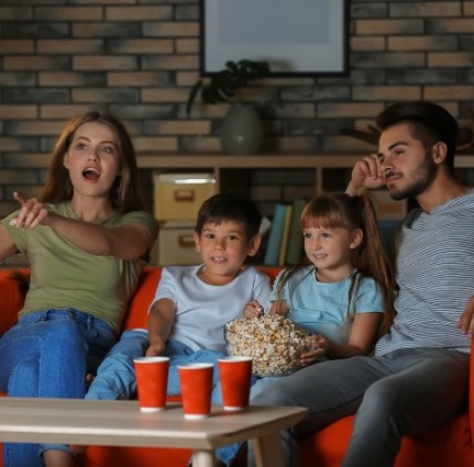 family watching movie together | Island Real Estate