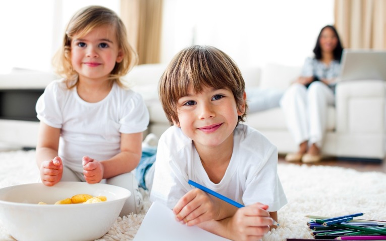 Kids coloring & eating chips | Island Real Estate