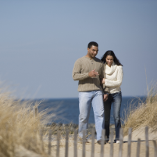 How to Have a Romantic Topsail Island Getaway | Couple taking walk on beach