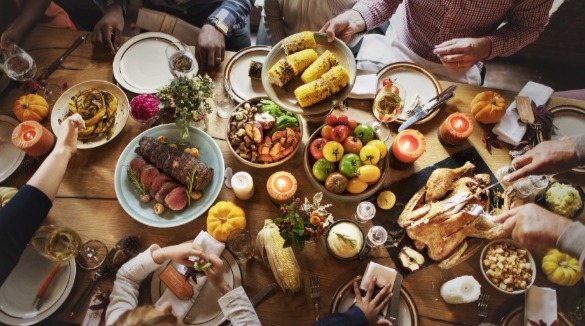 family enjoying thanksgiving dinner | Island Real Estate