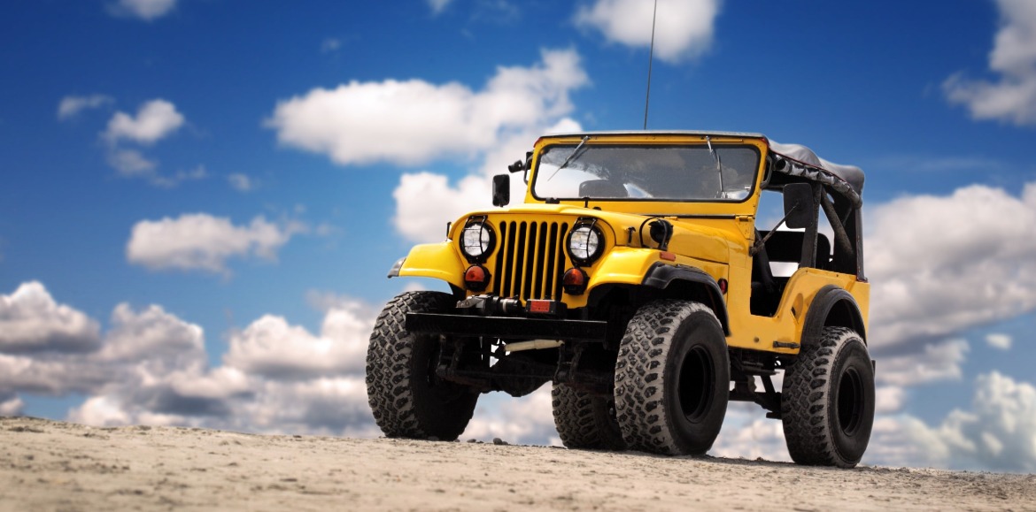 yellow Jeep on the beach | Island Real Estate