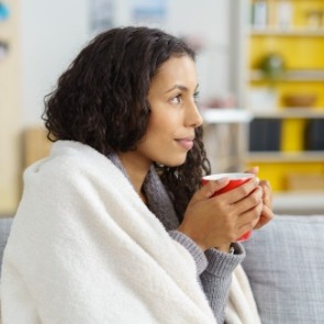 woman drinking warm drink | Island Real Estate