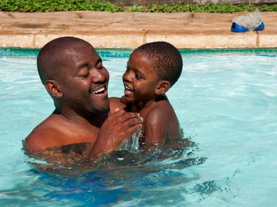 dad and son in pool